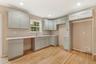 Kitchen with light wood finished floors and recessed lighting