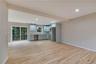 Kitchen with open floor plan, recessed lighting, light countertops, light wood-style floors, and beam ceiling