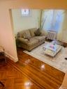 Living area featuring baseboards and radiator