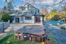 Back of house featuring a deck and a hot tub