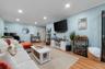 Living area with ornamental molding, light wood-style flooring, recessed lighting, and an office area