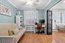 Office with radiator heating unit, a ceiling fan, wood finished floors, and ornamental molding