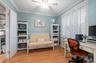 Home office featuring light wood finished floors, radiator, ornamental molding, and ceiling fan