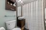 Full bath featuring curtained shower, vanity, and dark tile patterned floors