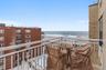 Balcony with grilling area and view of water and beach