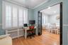 Home office featuring radiator heating unit, light wood finished floors, and crown molding