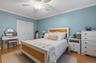Bedroom with crown molding, a ceiling fan, a closet, and light wood finished floors