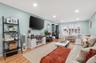 Living room with light wood finished floors, recessed lighting, and crown molding