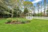 View of yard featuring a gazebo and view of wooded area