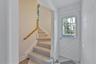 Entrance foyer featuring plenty of natural light, stairway, and light floors