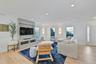 Living area featuring light wood-style flooring, crown molding, wainscoting, and recessed lighting