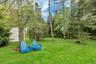 View of grassy yard featuring a storage shed