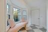 Mudroom featuring light flooring and baseboards