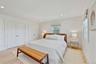 Bedroom featuring two closets, light wood-style floors, and recessed lighting