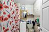 Bathroom with tile walls, a shower with shower curtain, and vanity