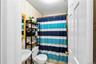 Full bathroom with a shower with shower curtain and tile patterned flooring