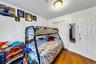 Bedroom with a closet and wood-type flooring