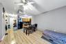 Bedroom featuring freestanding refrigerator, a baseboard radiator, and a ceiling fan