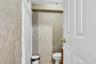Bathroom with tile walls, vanity, and tile patterned flooring