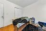 Bedroom with hardwood / wood-style flooring and a closet
