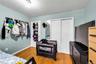 Bedroom with multiple closets and light wood finished floors