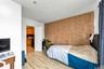 Bedroom featuring wallpapered walls and an accent wall