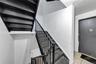 Stairway with tile patterned floors and baseboards