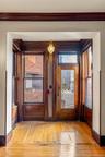 Doorway to outside featuring crown molding and wood-type flooring