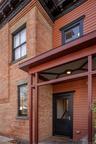Doorway to property featuring brick siding