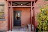 Doorway to property featuring brick siding