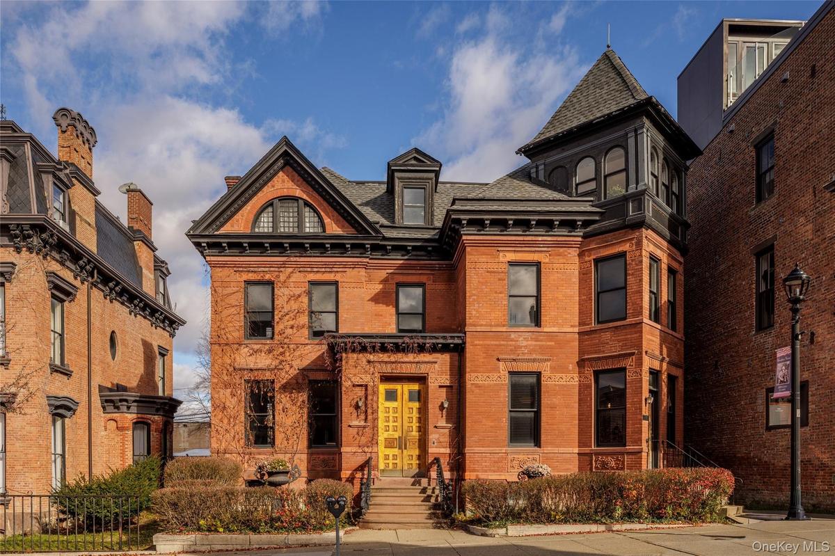 Victorian home with brick siding