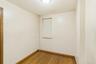 Unfurnished room with wood finished floors and baseboards