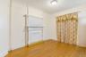 Unfurnished living room featuring ornamental molding, light wood-type flooring, and a textured ceiling