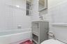 Bathroom featuring vanity, tile walls, and shower / washtub combination