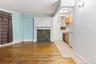 Unfurnished living room featuring light wood-style floors and baseboards