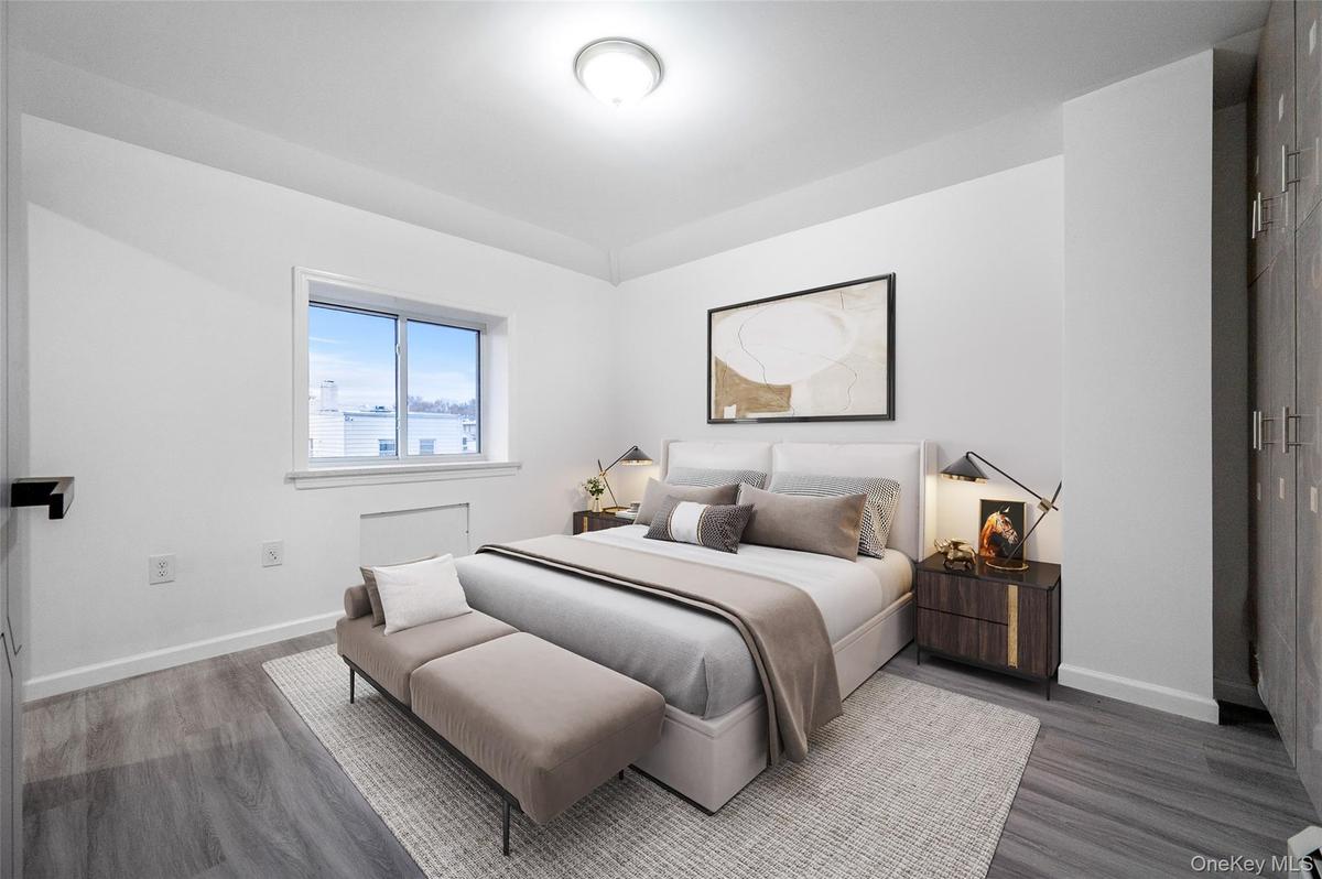 Bedroom with baseboards and wood finished floors