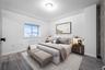 Bedroom with baseboards and wood finished floors
