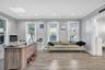 Office space featuring light wood-style floors, crown molding, recessed lighting, a skylight, and baseboard heating
