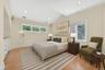 Virtually Staged Bedroom with vaulted ceiling, ornamental molding, recessed lighting, light wood-style flooring, and multiple windows
