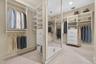 Virtually Staged Walk in closet with light carpet