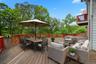 Virtually Staged Wooden terrace featuring outdoor dining area and an outdoor living space