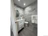 Bathroom featuring vanity and tile walls
