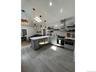 Kitchen featuring a peninsula, open shelves, pendant lighting, appliances with stainless steel finishes, and dark wood-type flooring