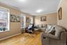 Living room with crown molding and light wood finished floors