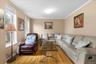Living room featuring ornamental molding and wood finished floors