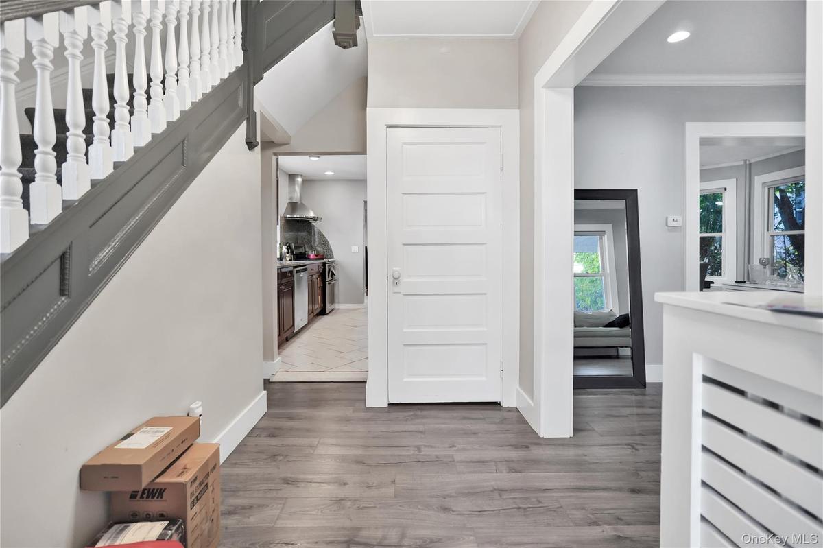 Entryway with recessed lighting, dark wood finished floors, and crown molding