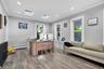 Office with plenty of natural light, wood finished floors, recessed lighting, crown molding, and a baseboard radiator