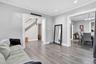 Living area with ornamental molding, light wood-style floors, stairway, and recessed lighting