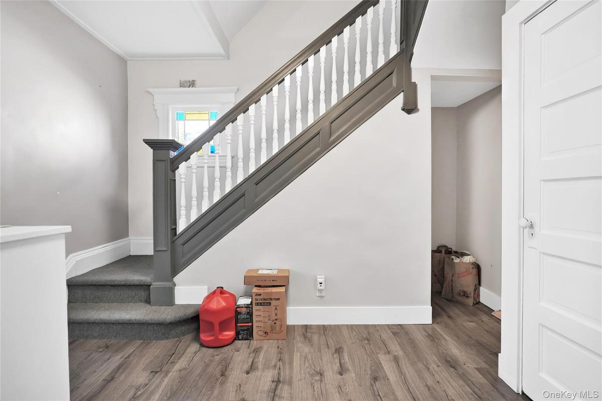 Stairway with baseboards and wood finished floors
