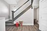 Stairway with baseboards and wood finished floors